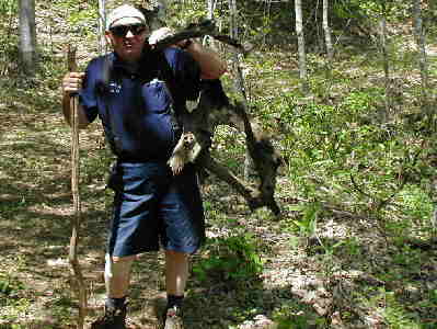 A mountain man carrying firewood.