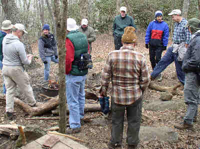 We gather around the campfire as it starts to snow.