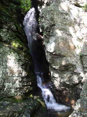 Raven Cliff Falls empties through the large split cliff.
