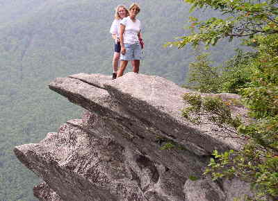 Lynne and Wanda standing on this amazing rock cliff.
