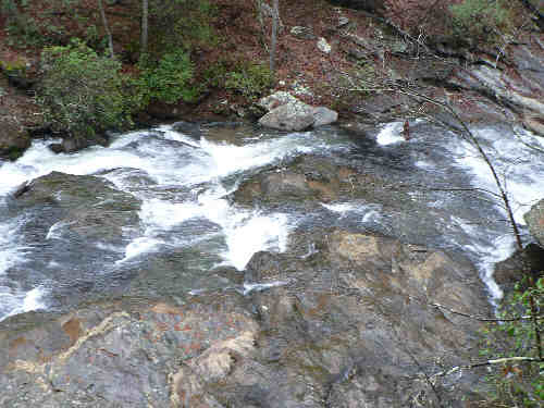Here, the creek rushes over a solid rock face.