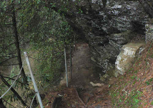 Here, the trail passes under another rock ledge.