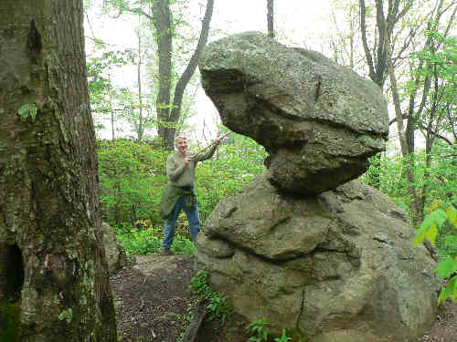 The amazing balanced boulder near Neels Gap. John is checking the stability of the boulder!