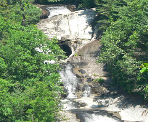 Zooming in on the top of the falls, you can see a cave opening.
