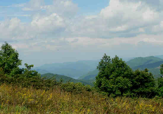 Walking up the grassy slope to Siler Bald, we can see Lake Nantahala in the valley below.