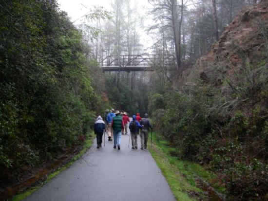 This is a narrow portion of the trail passing under the old metal bridge.
