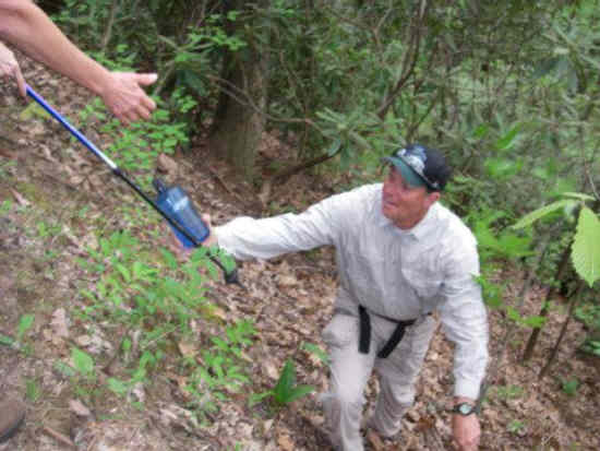 Joe retrieves one of our water bottles that was accidently dropped and it tumbled about 200 feet down a steep slope.