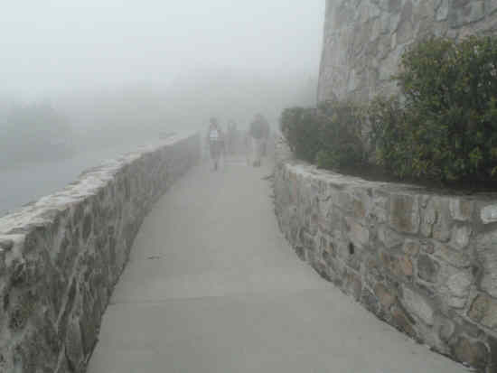 Walking up the sidewalk to the center.