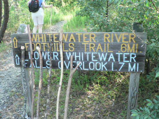 Trail sign at the start along with extra hiking sticks.