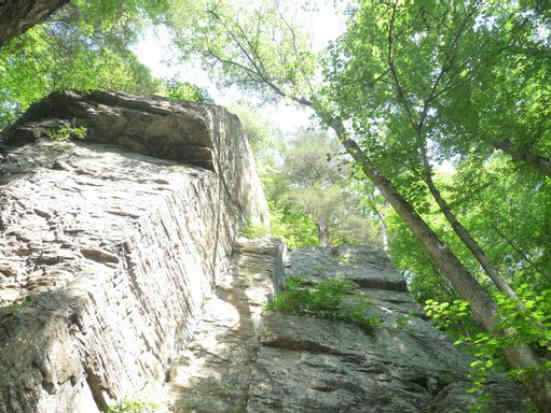 Looking up the massive rock cliffs.