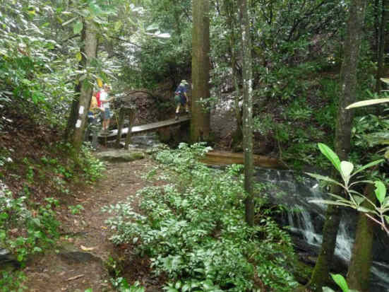 Crossing a creek on a footbridge.