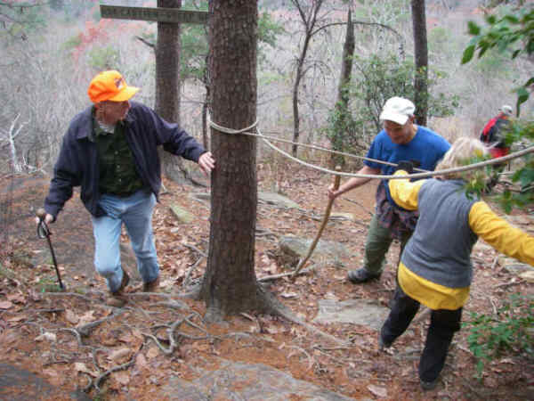 There is a rope near the rock that helps prevent slips and falls.