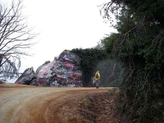 Passing by the graffiti covered boulders near the summit.