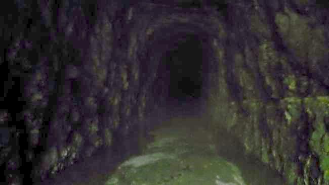 Walking into the cool, dark, moist solid rock tunnel.