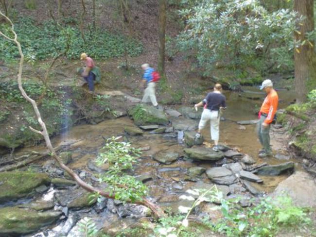 Rock hopping across a side creek.