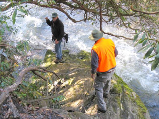 Finding the engraved rock at the state line requires scrambling down some slippery rocks to the edge of the river.