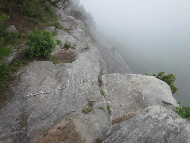 The amazing rock cliffs were fogged in. Here you can see a rapelling cable that Army Rangers use.