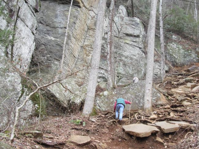 Climbing up the slope to the massive rock cliffs!