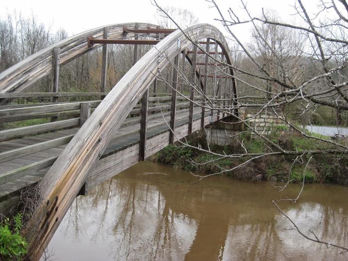 The next bridge is a beautiful wooden arched bridge.