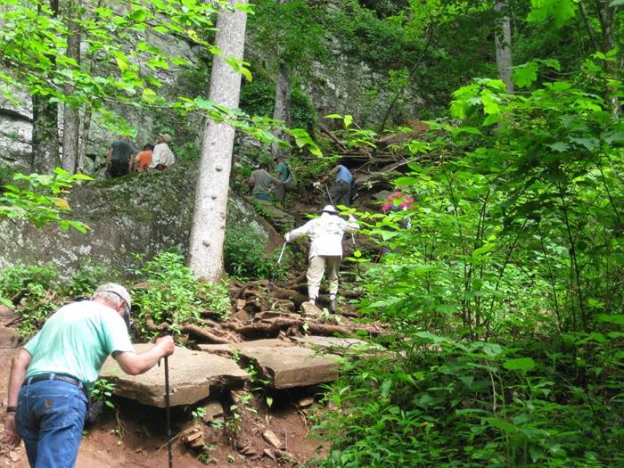 We carefully climb the steep slope to the base of the cliffs.