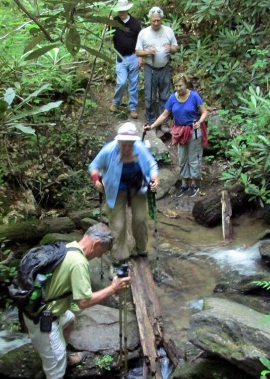 Walking up from the river to the falls, we rock hop across a tricky spot.