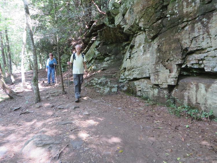 Here, the trail passes by a large rock cliff.