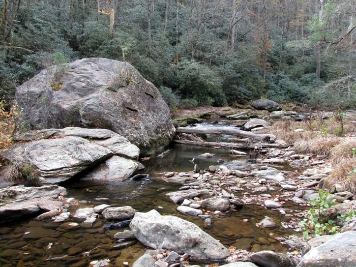 The giant boulder in the river is about .2 miles from Ellicott Rock.