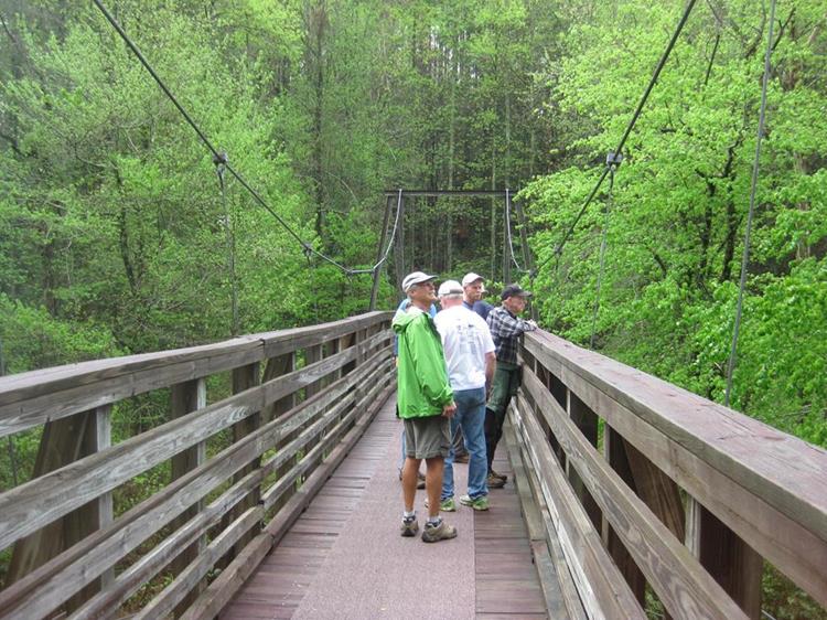 On the Shortline Trail crossing the suspension bridge over the river.