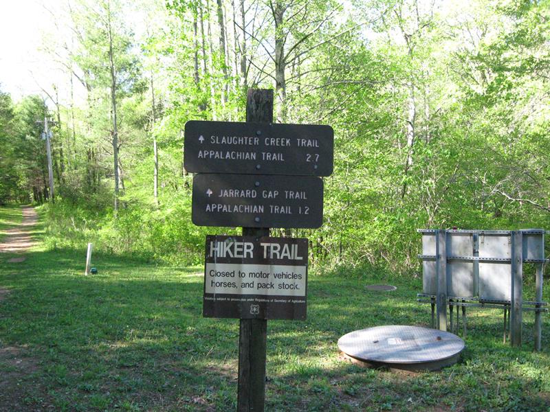 The trailhead sign just across from the dam.