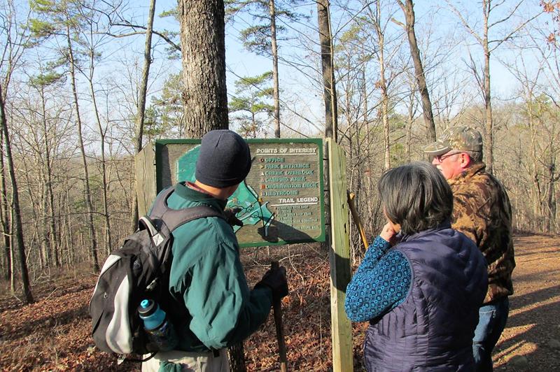 Checking the trail sign near the golf course.